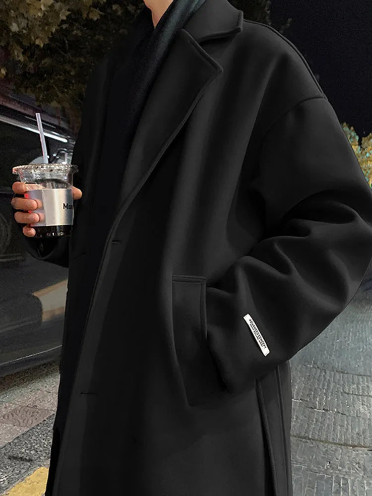 Men's British style mid-long wool coat in khaki with side seam pockets on a hanger