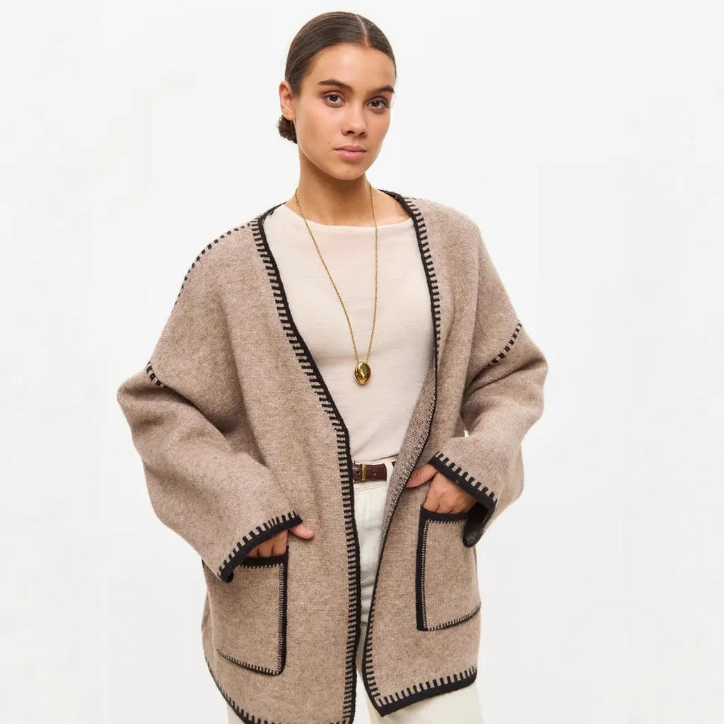 Loose mid-length knitted cardigan with lace-up front, in white, black, or camel.