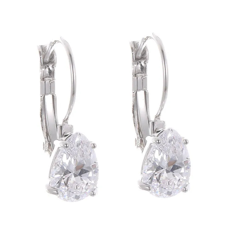 Gold and platinum drop earrings with a cubic zirconia stone set in a simple metal design.
