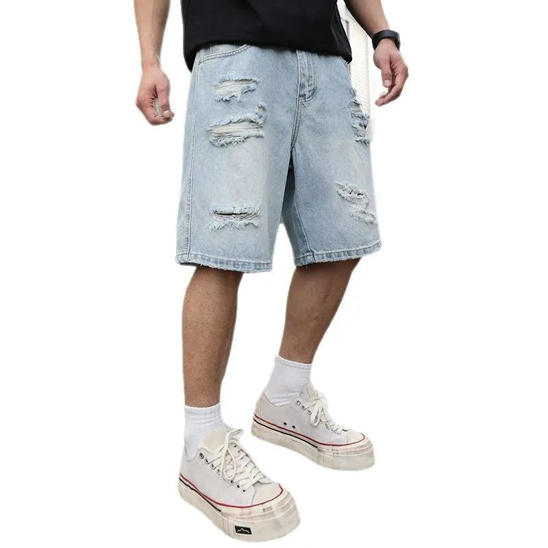 Light blue distressed denim shorts with ripped detailing and straight cut design on mannequin