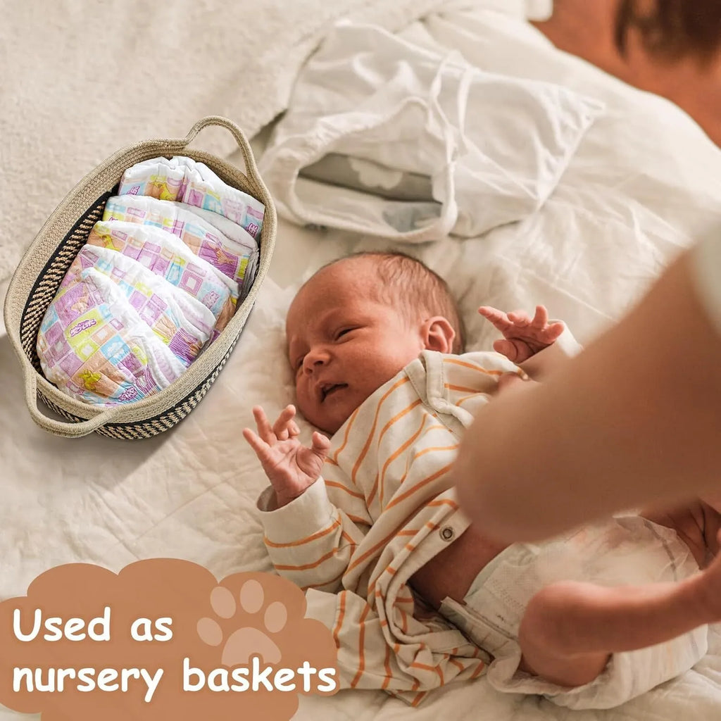 Handmade light beige cotton rope woven storage basket with handle on a wooden surface