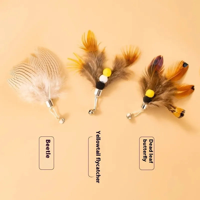 Three steel wire cat toys shaped like small flying insects on a plain background.