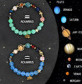 Two natural stone beaded bracelets with zodiac charms on a table, showing adjustable sliding knots.