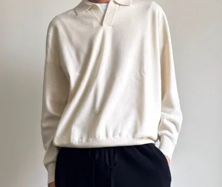 Man wearing a milky white pure wool polo collar sweater with a lapel design.