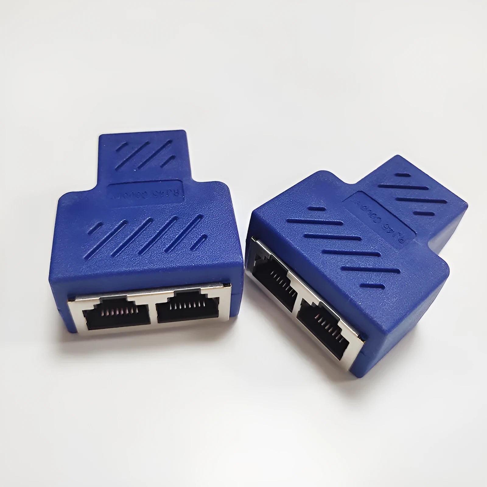 Two white RJ45 network cable splitter adapters showing one male and two female Ethernet ports.