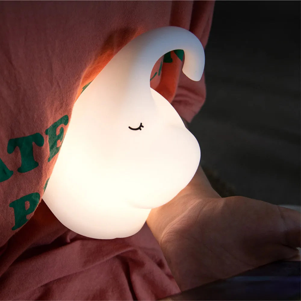 DOMI elephant-shaped silicone night light in warm white, showing its compact size.