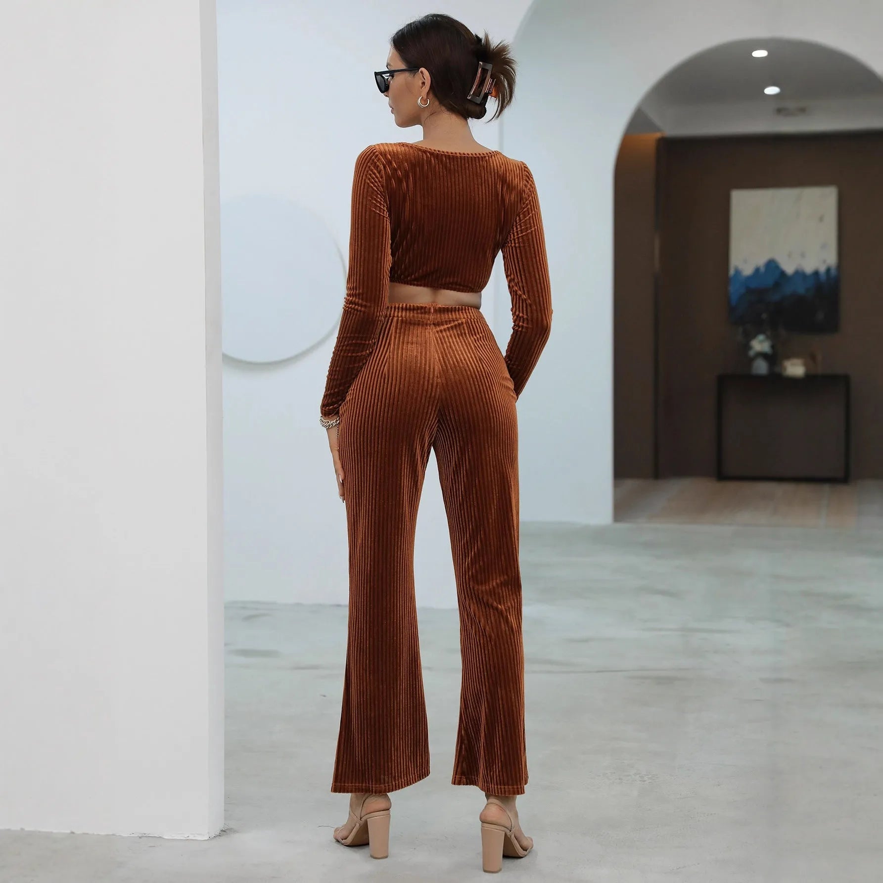 Caramel-coloured women's long sleeve sweater and trousers casual set on a hanger.