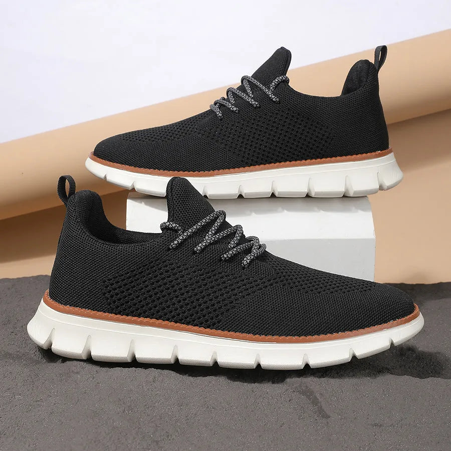 Men's grey and black casual sneakers with woven mesh upper and round toe.