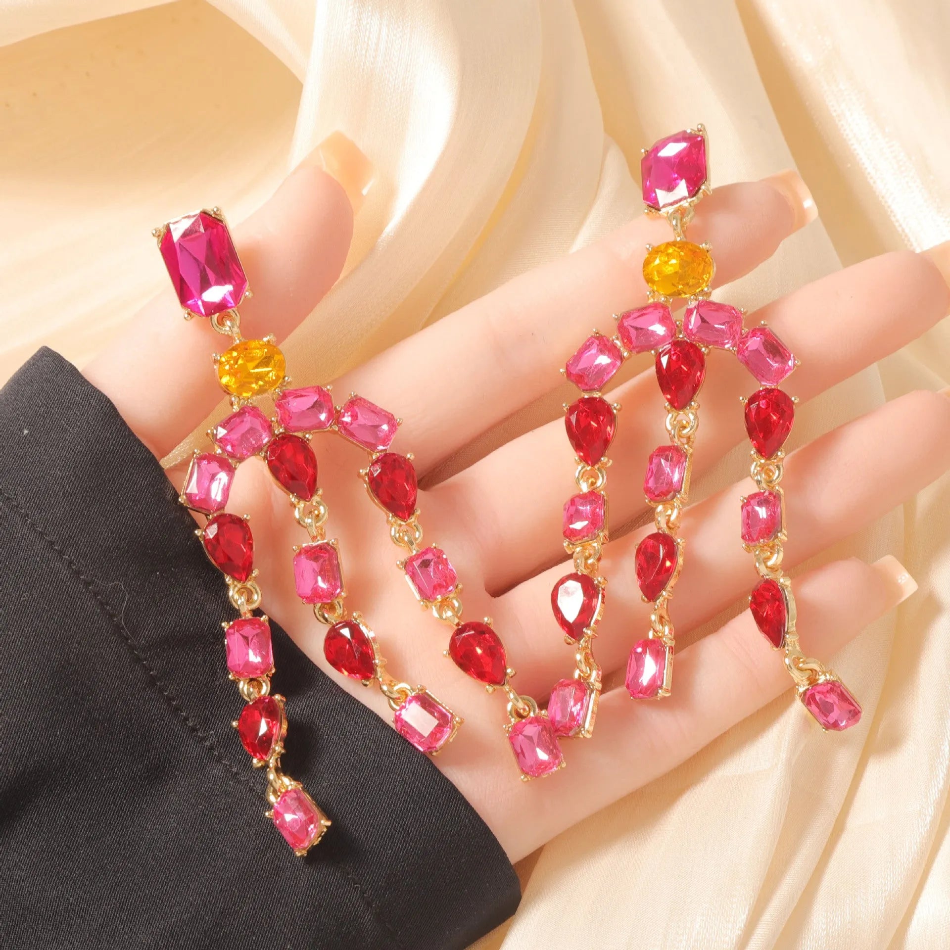 Heavy-duty full-drop diamond teardrop fringe earrings in zinc alloy, green colour, on display