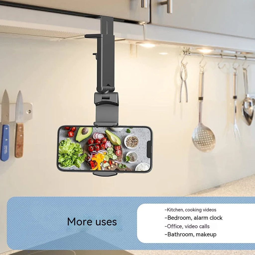 Black foldable rotating universal phone holder shown open on a desk, holding a smartphone.