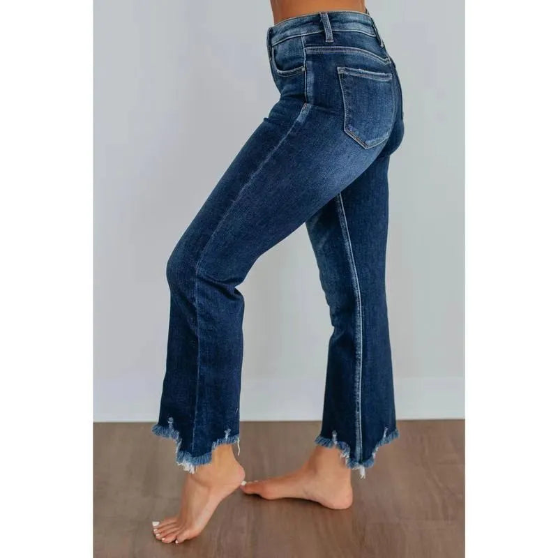 Women's solid blue casual denim trousers with a hand-worn finish on a hanger.