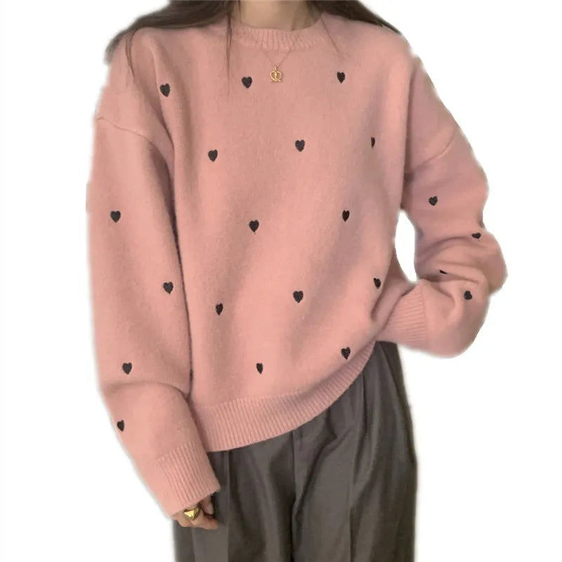Women's loose grey acrylic pullover sweater with embroidery on the front.