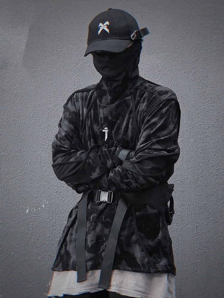 Man wearing a black tie dye print loose pullover sweater with drop-shoulder sleeves.