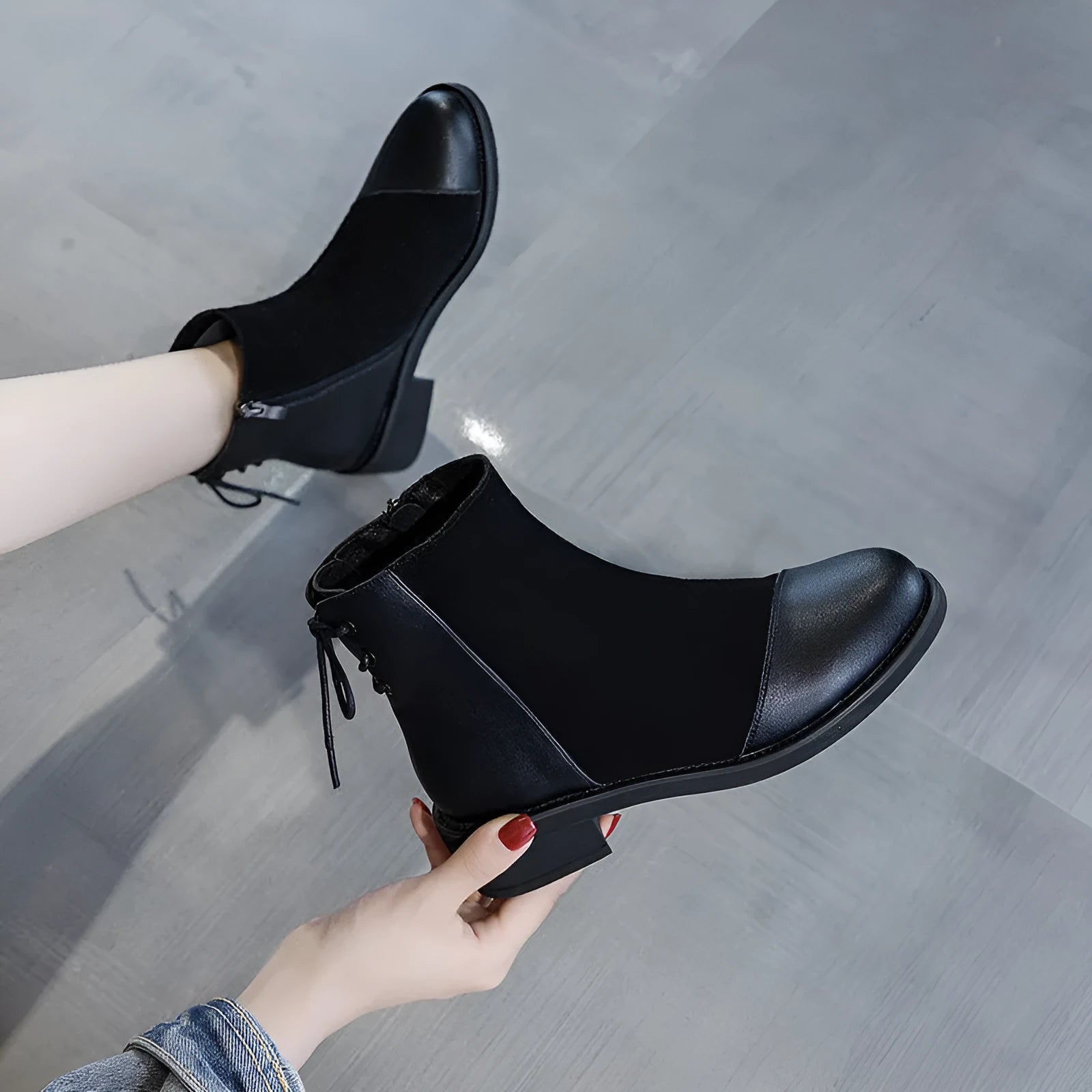 Black women's knee-high Martin boots with side zip, round toe, and block heel on a rubber sole.