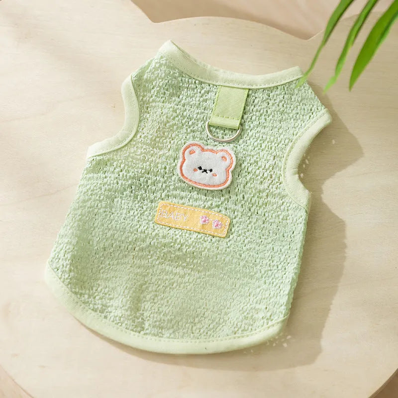 Cat wearing green knitted clothes with hollowed-out bear patch design