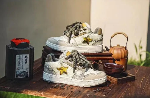 Green low-top casual sneakers with a star pattern design, round toe, and thick rubber sole.