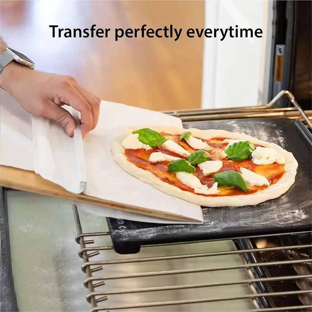 Food-grade PP plastic pizza transfer shovel on a kitchen counter, showing its size and hanging hole.