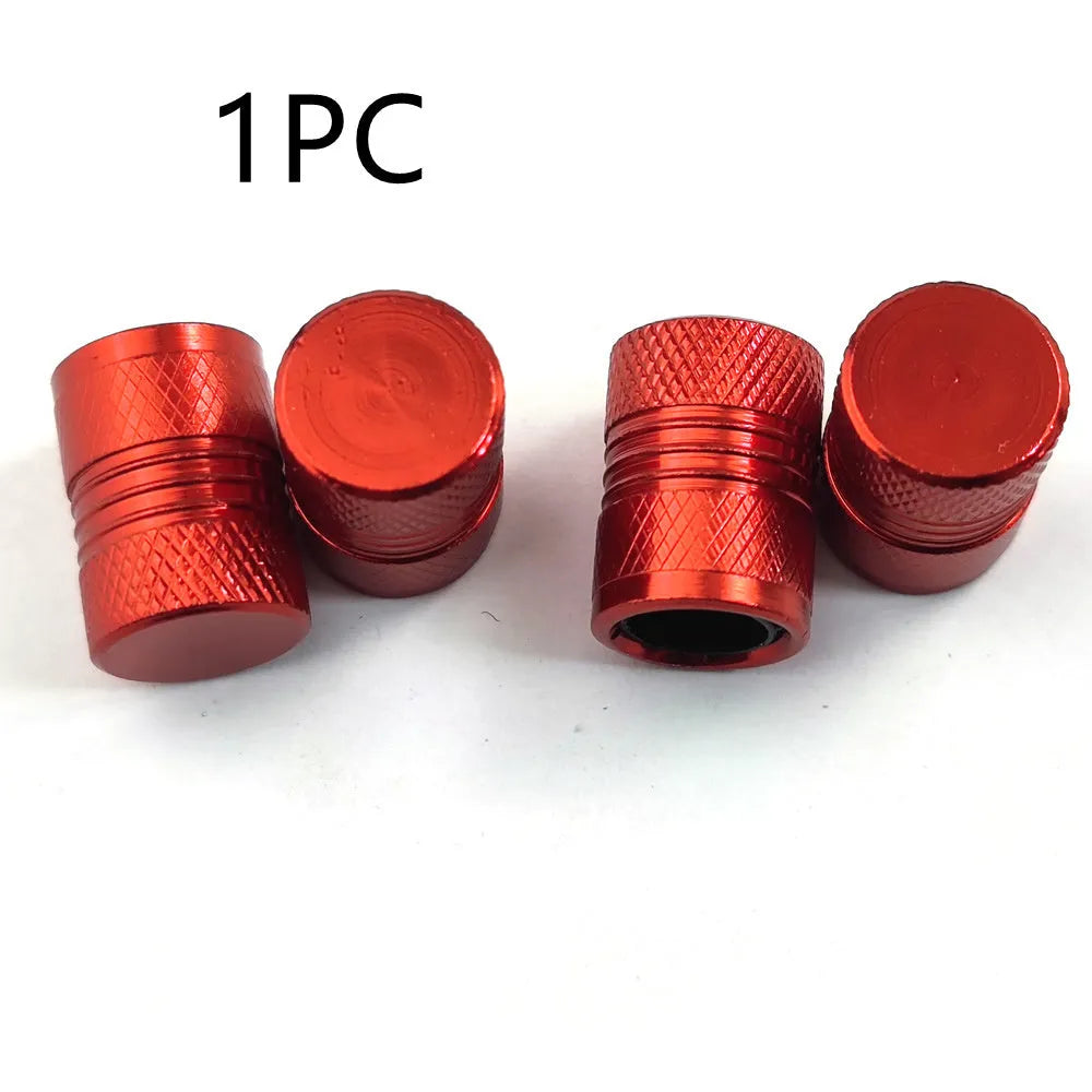Aluminium car tyre valve dust cap in black, blue, grey, and red colours.