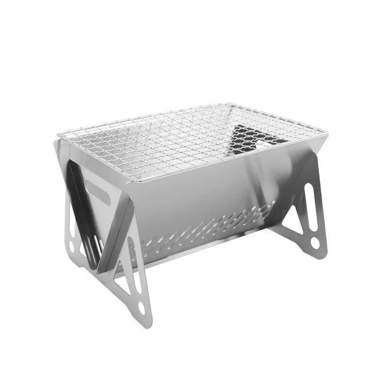Large foldable stainless steel barbecue oven with storage bag, set up for outdoor use.