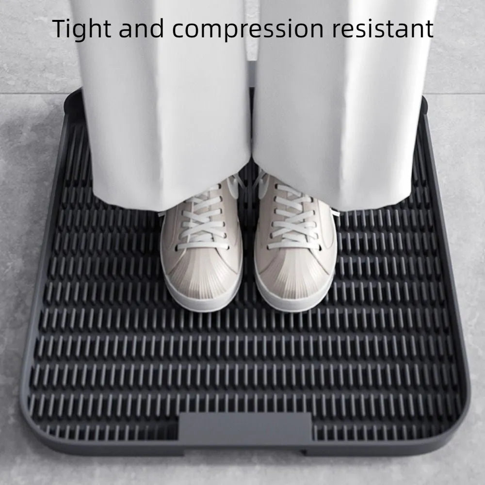 Large black cat litter pedal with slanted mouth and textured grooves beside a litter tray