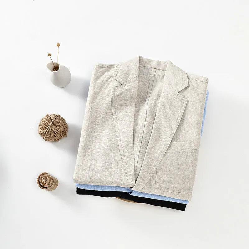 Men's solid colour linen suit jacket on a hanger, showing single-breasted front and size stick pocket detail.