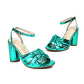 Gold women's high-heel peep-toe sandals with an adjustable ankle buckle on a white background.