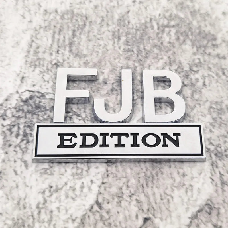 FJB EDITION zinc alloy car badge in black-red colourway for GM vehicles measuring 8x5cm
