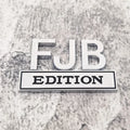 FJB EDITION zinc alloy car badge in black-red colourway for GM vehicles measuring 8x5cm