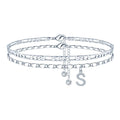 Silver-coloured copper anklet with a double-circle bead engraved with a letter.