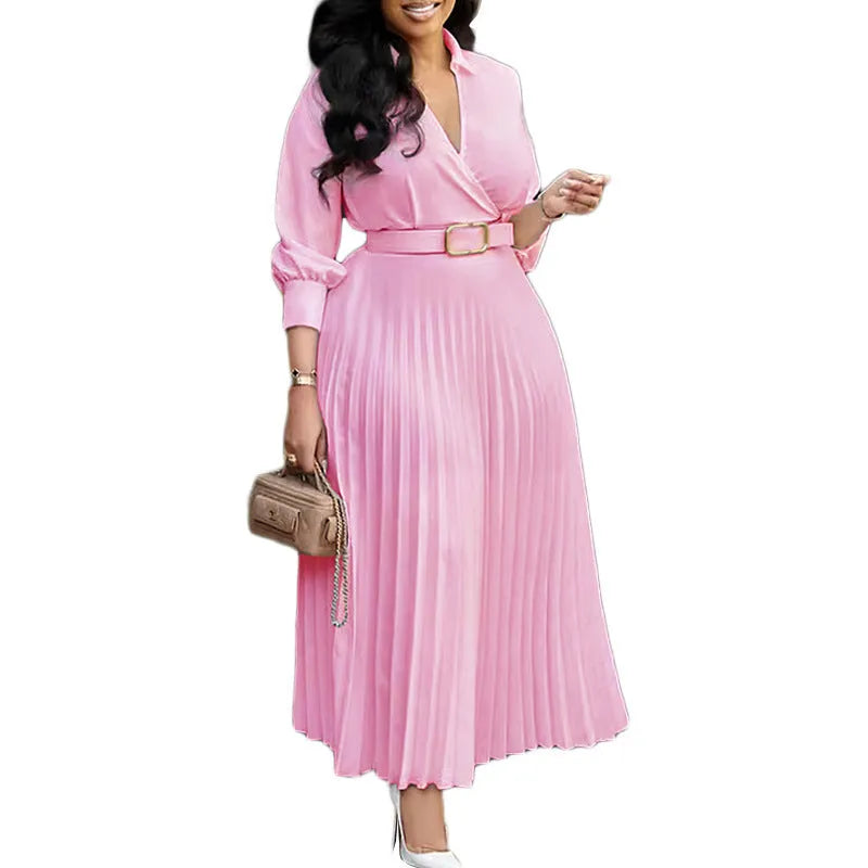 A woman's mid-length pleated swing dress with a polo collar, three-quarter sleeves, and an integrated belt at the high waist.