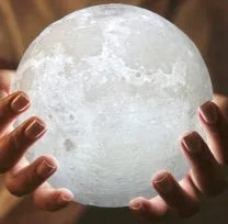 3D printed spherical moon lamp showing lunar surface texture on wooden holder
