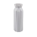 A green drop-resistant plastic melamine vase with a wide 7.2cm base on a wooden table.