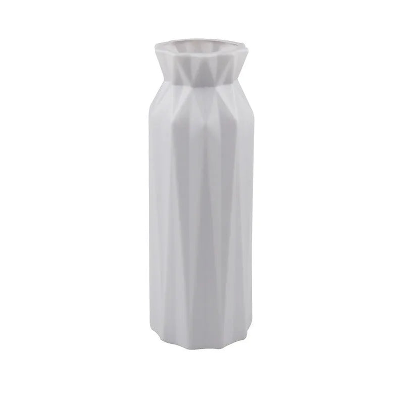 A green drop-resistant plastic melamine vase with a wide 7.2cm base on a wooden table.