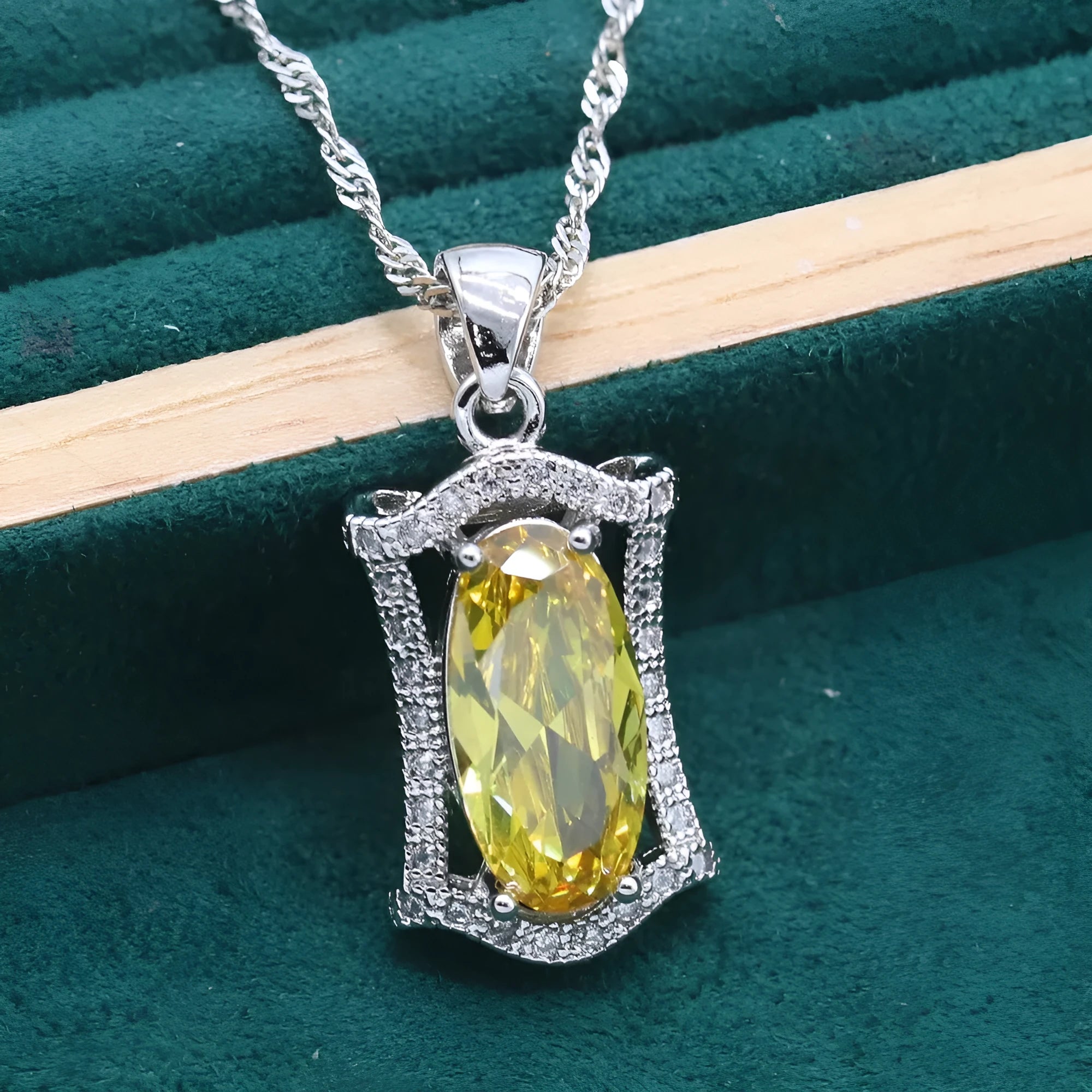 Women's anti-allergy zircon jewellery set in yellow with necklace, earrings, ring, and bracelet on display.