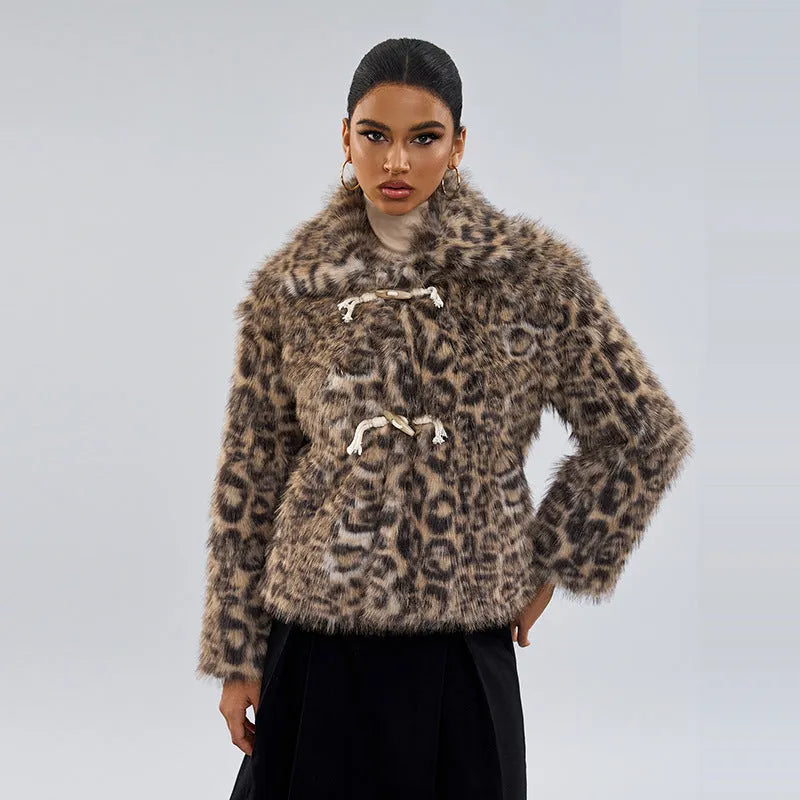Women's leopard print coat with a buckle lapel, shown in street fashion style.