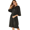 Women's black A-line midi dress with long sleeves, elastic cuffs, and a cinched elastic waist belt.