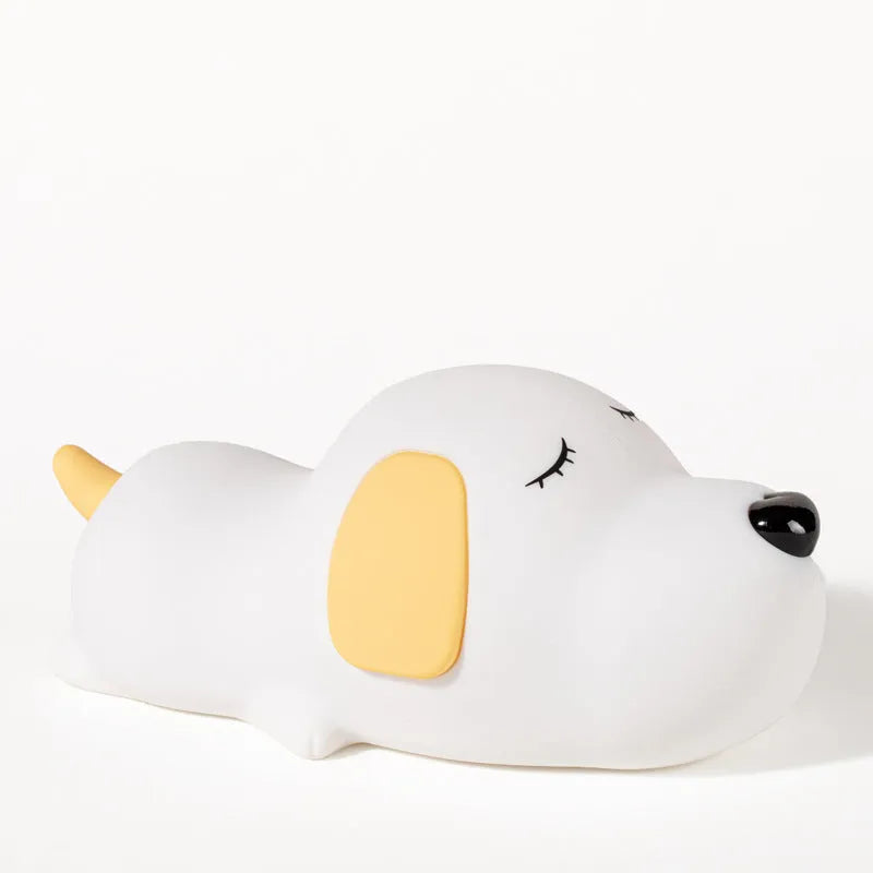 Small two-tone cartoon dog shaped silicone night lamp with USB charging port.