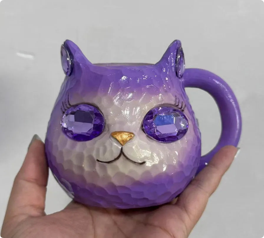 Clear resin Cat Cup ornament in purple, green, blue, and pink colour options on display.