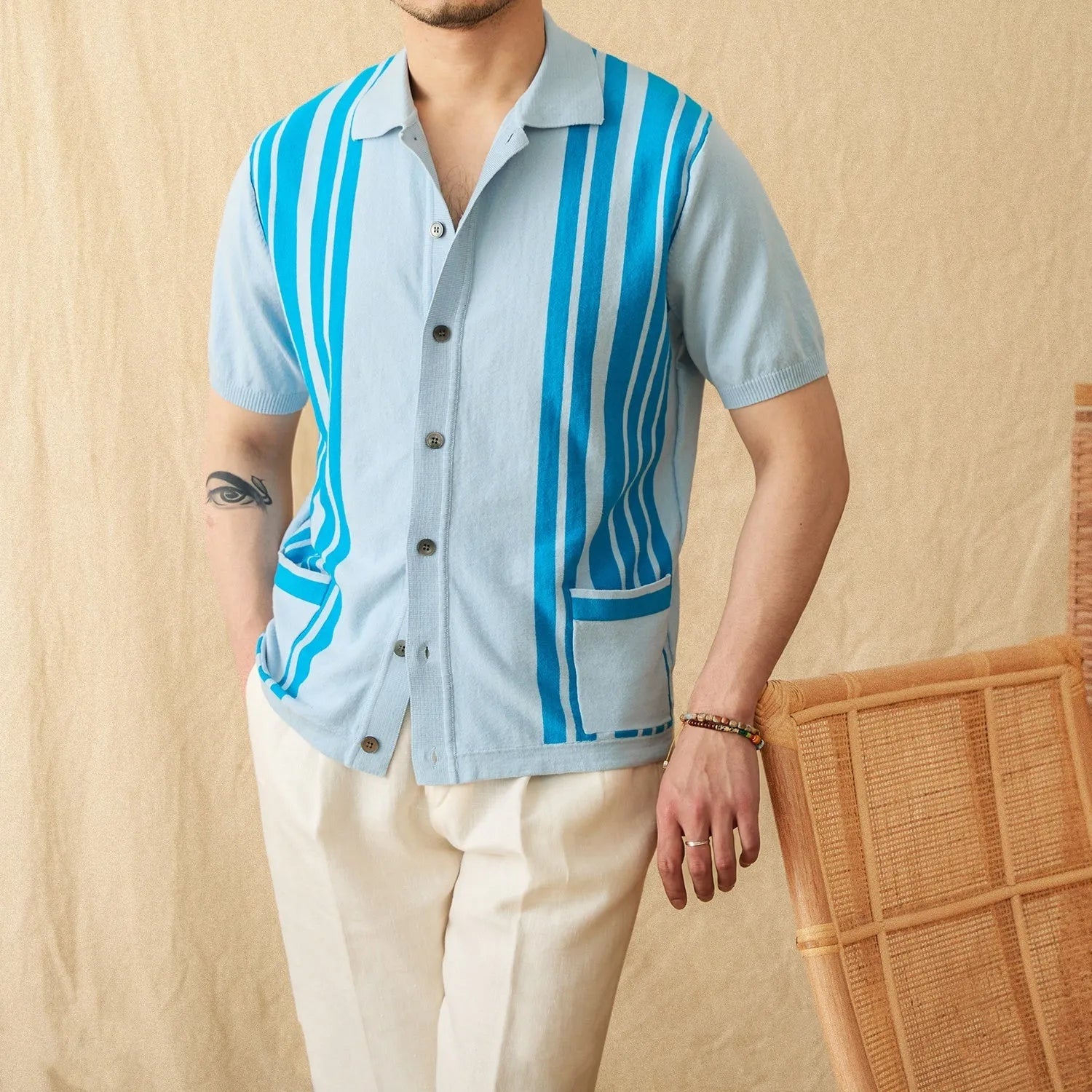 Royal blue striped cotton cardigan polo shirt with lapel collar and short sleeves laid flat