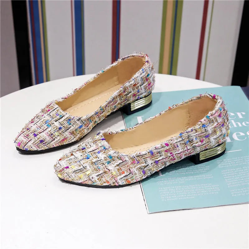Women's black and white canvas flats with pointed toe and lace-up design