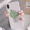 White silicone iPhone case with a detailed green plant pattern on the back, showing full device coverage.