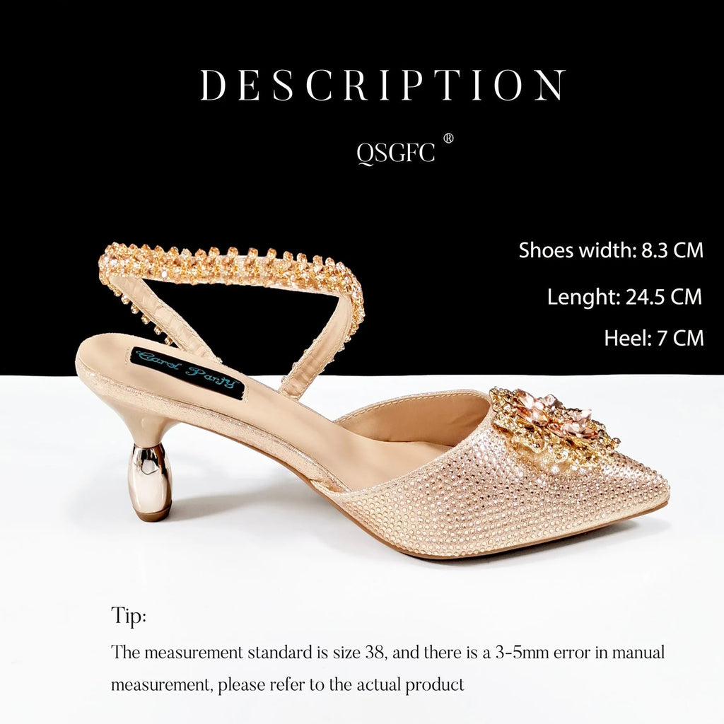 Women's black high heel and matching clutch bag set with floral decoration and rhinestones.