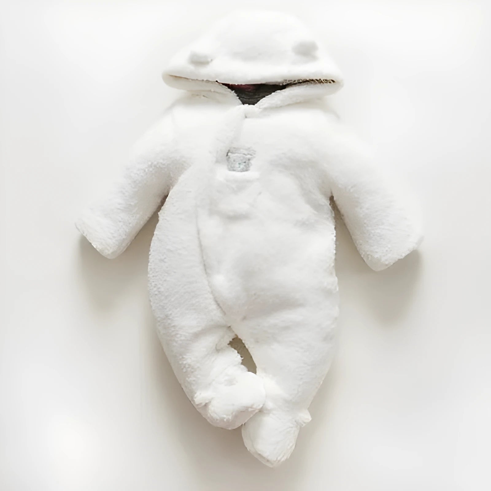 Baby wearing white cotton padded romper with lamb design and feet covers
