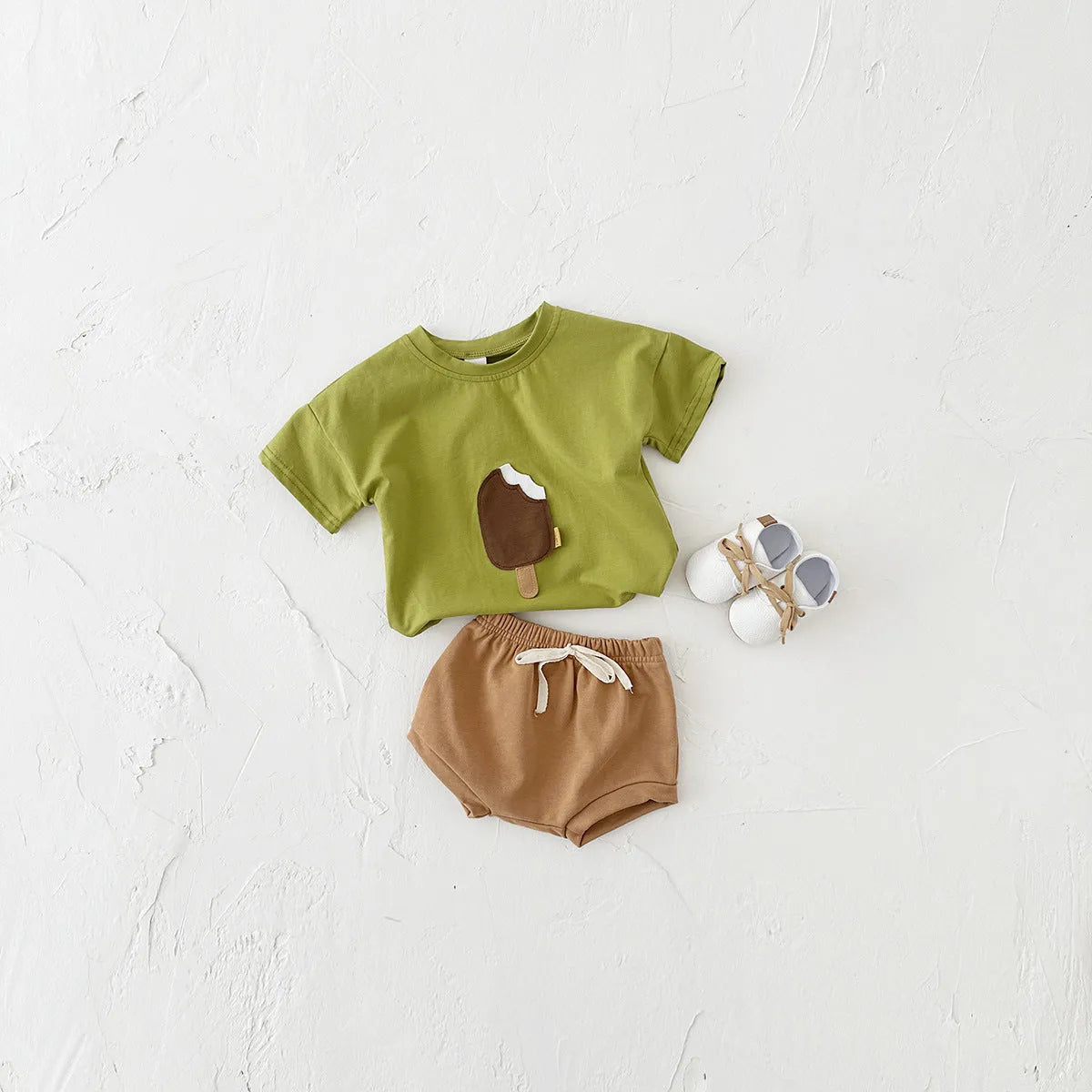Girls' olive green cotton shorts suit set with ice cream patch detail on short sleeve shirt.