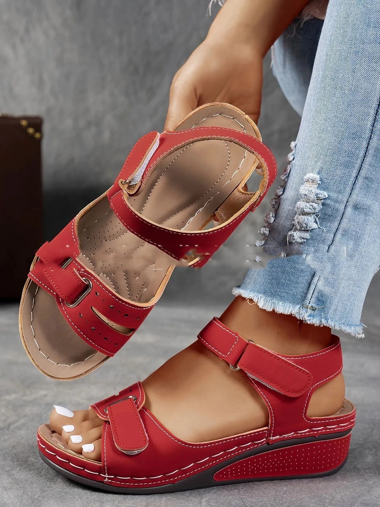 Women's beige strap sandals with a Velcro fastener and thick composite sole, shown in a round toe design.