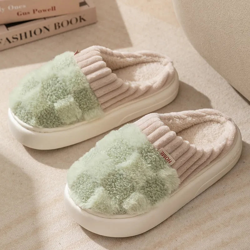Plaid pattern women's plush slippers with round toe and flat heel on a coloured background.