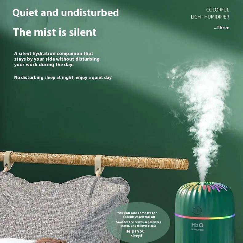 Small green animal-shaped USB aromatherapy humidifier on a desk