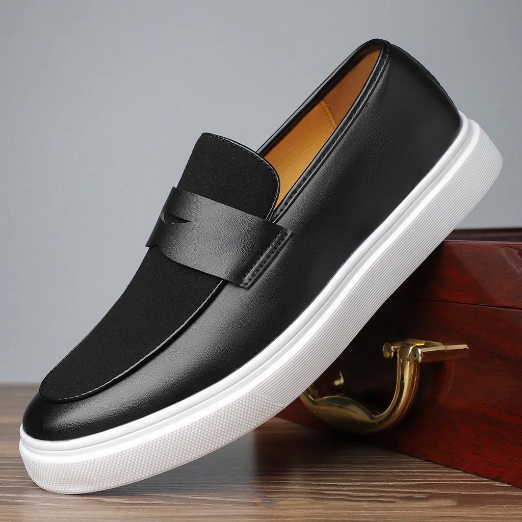 Black men's British-style slip-on casual shoes with a round toe and tassel detail on the upper.