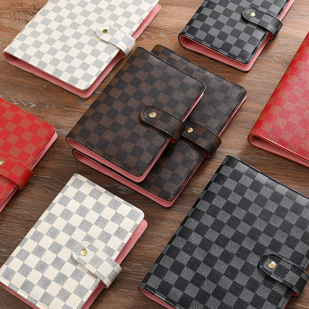 Loose-leaf checkered notebook with imitation leather cover in red, black, white or brown, showing ring binder and A5 size.