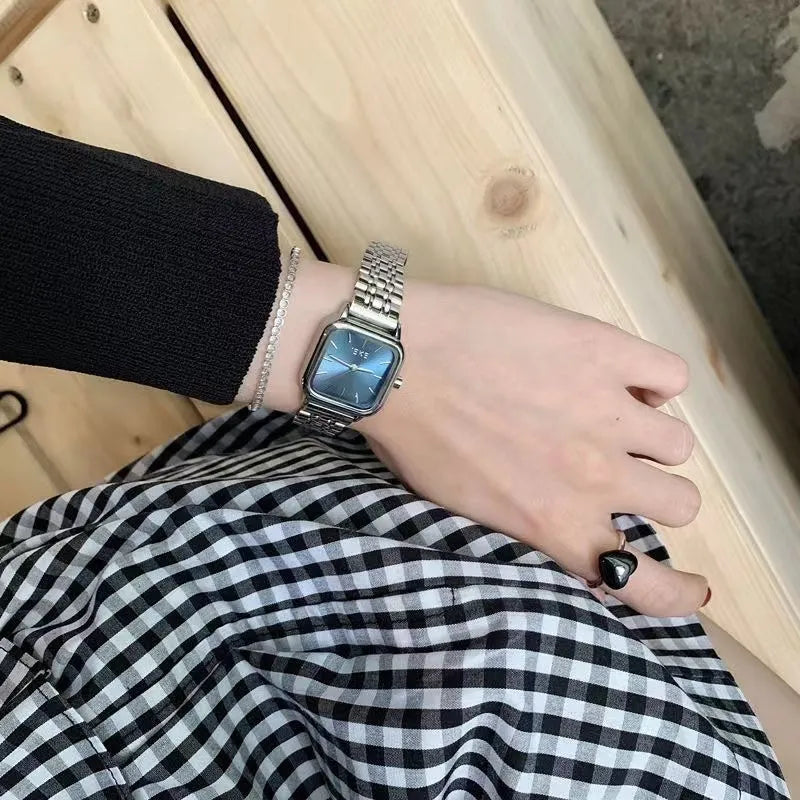 Women's retro quartz watch with slim 8mm case and bamboo band in blue, showing simple dial